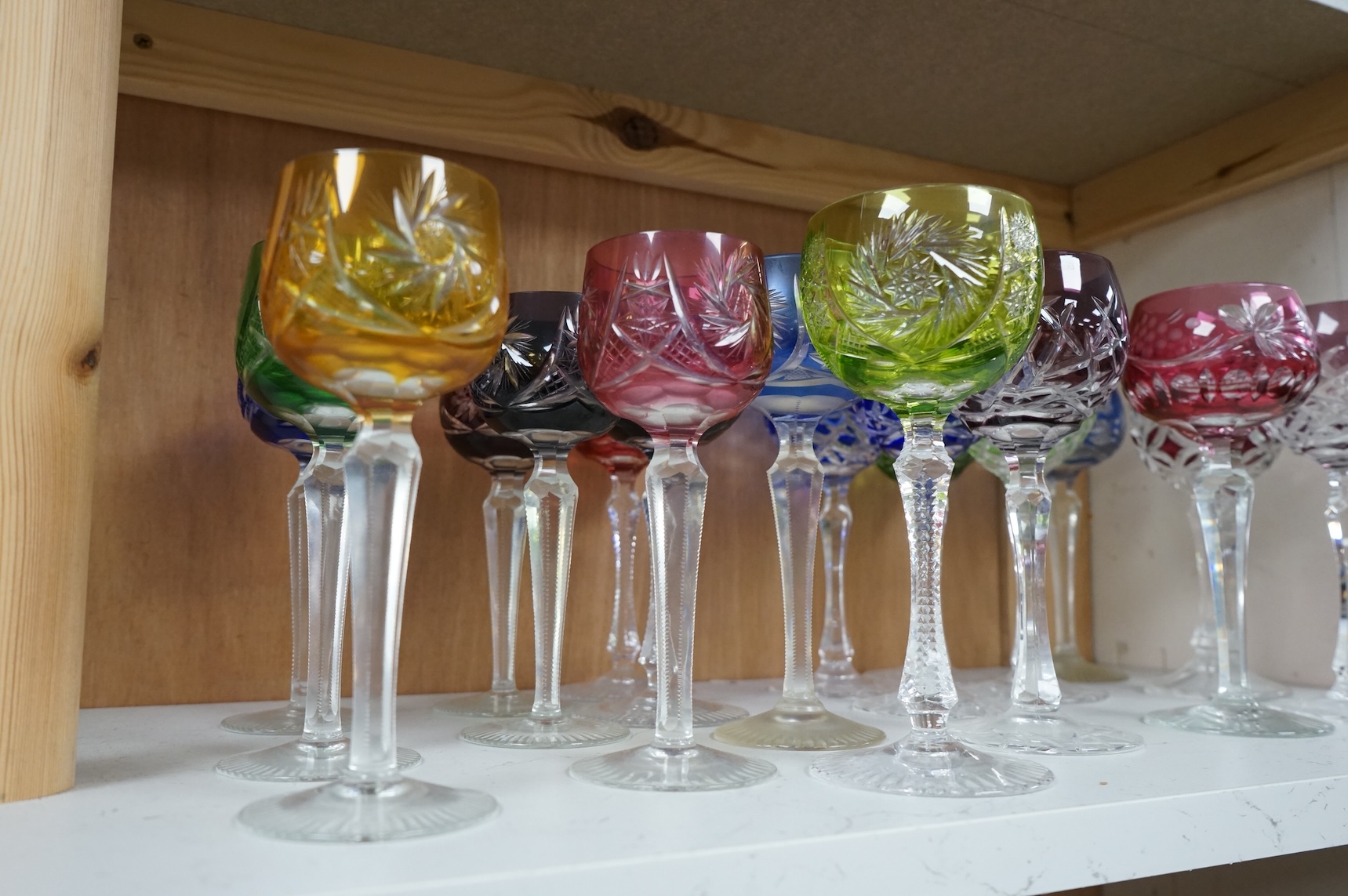 Twenty various Bohemian cut wine glasses, with coloured bowls, 21cm high.